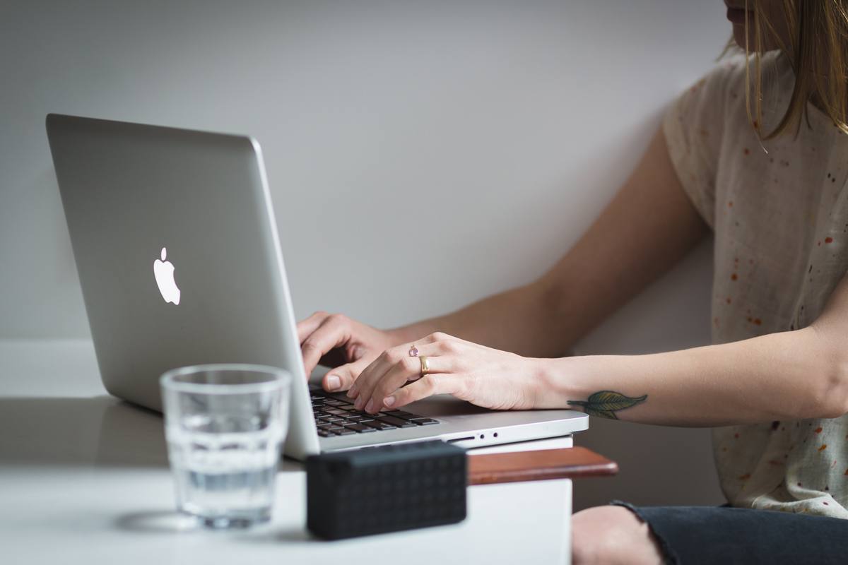 Worker typing on their laptop