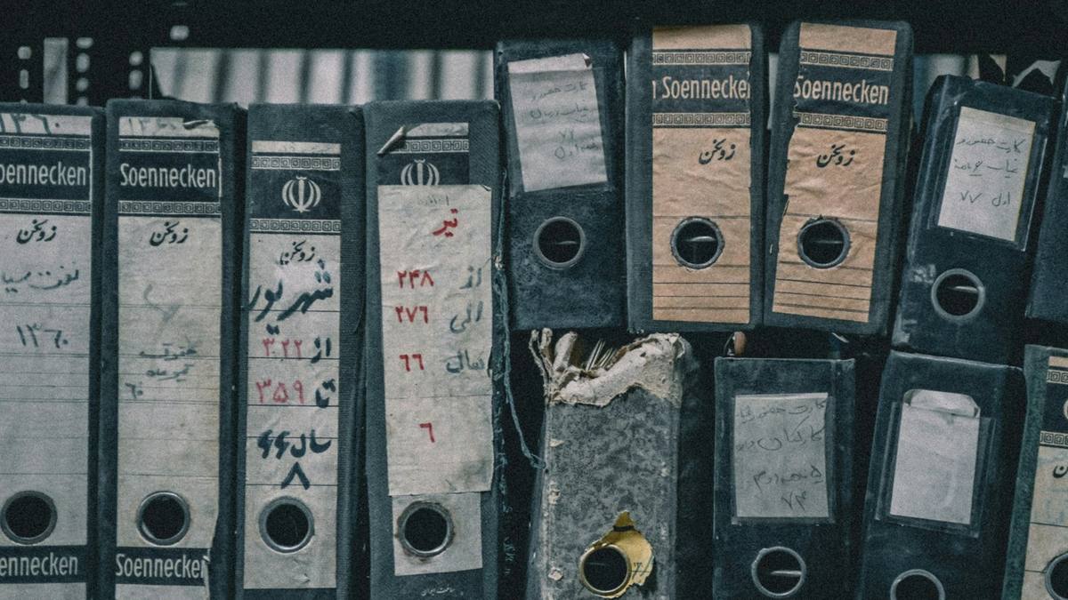 Rows of old box files on a shelf
