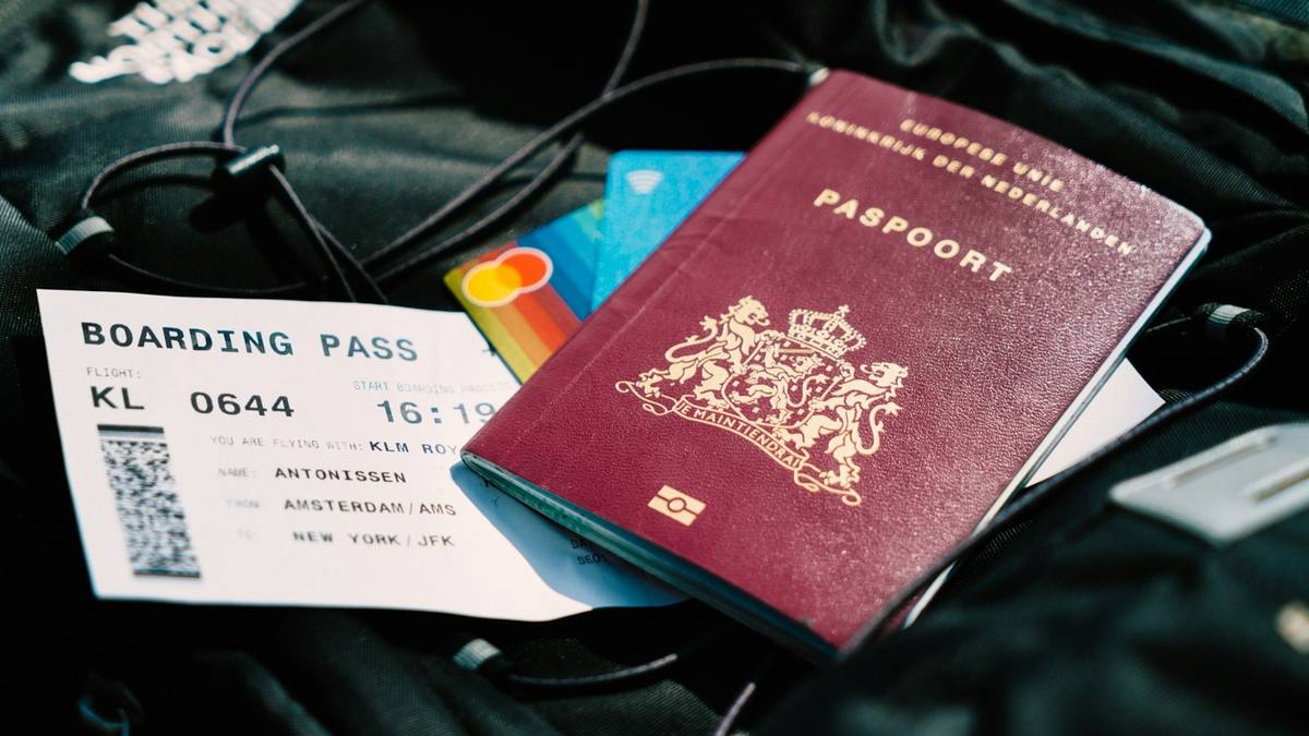 A passport and a boarding pass resting on a travel bag