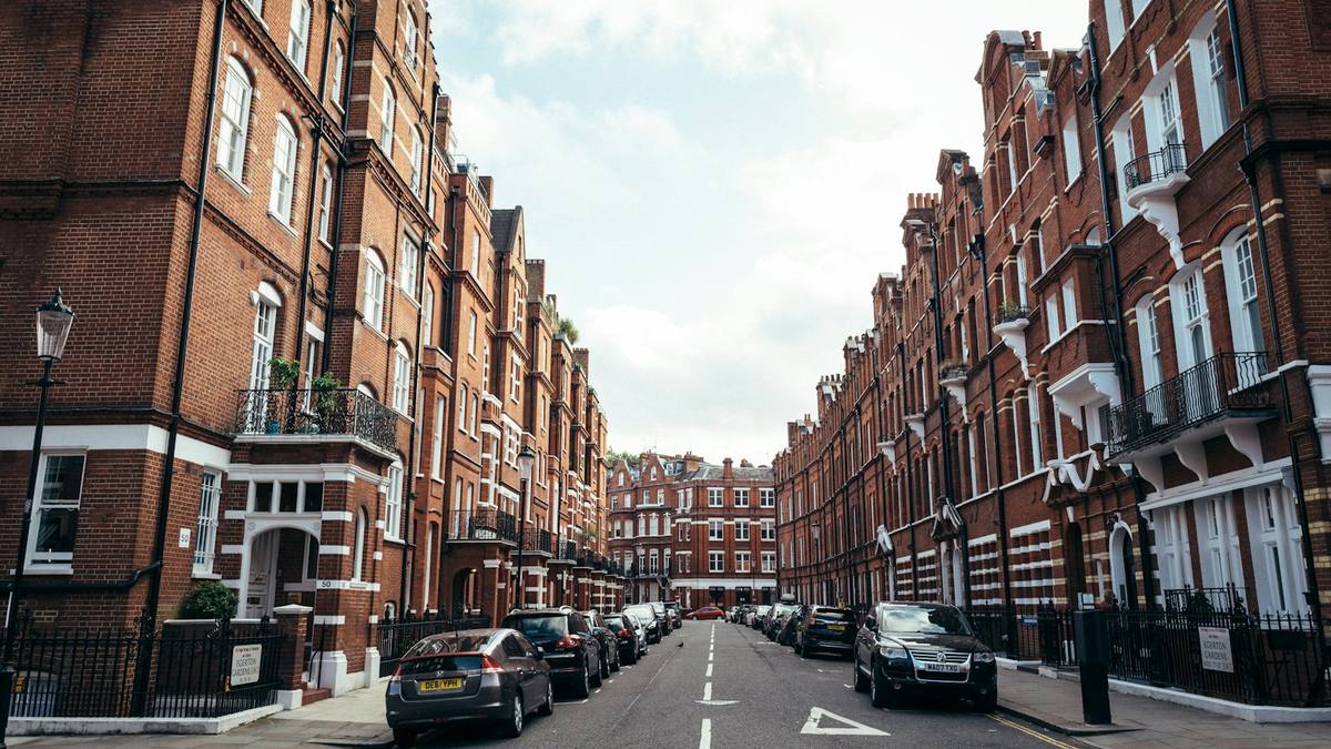 Red-brick Victorian mansion blocks lining a residential street