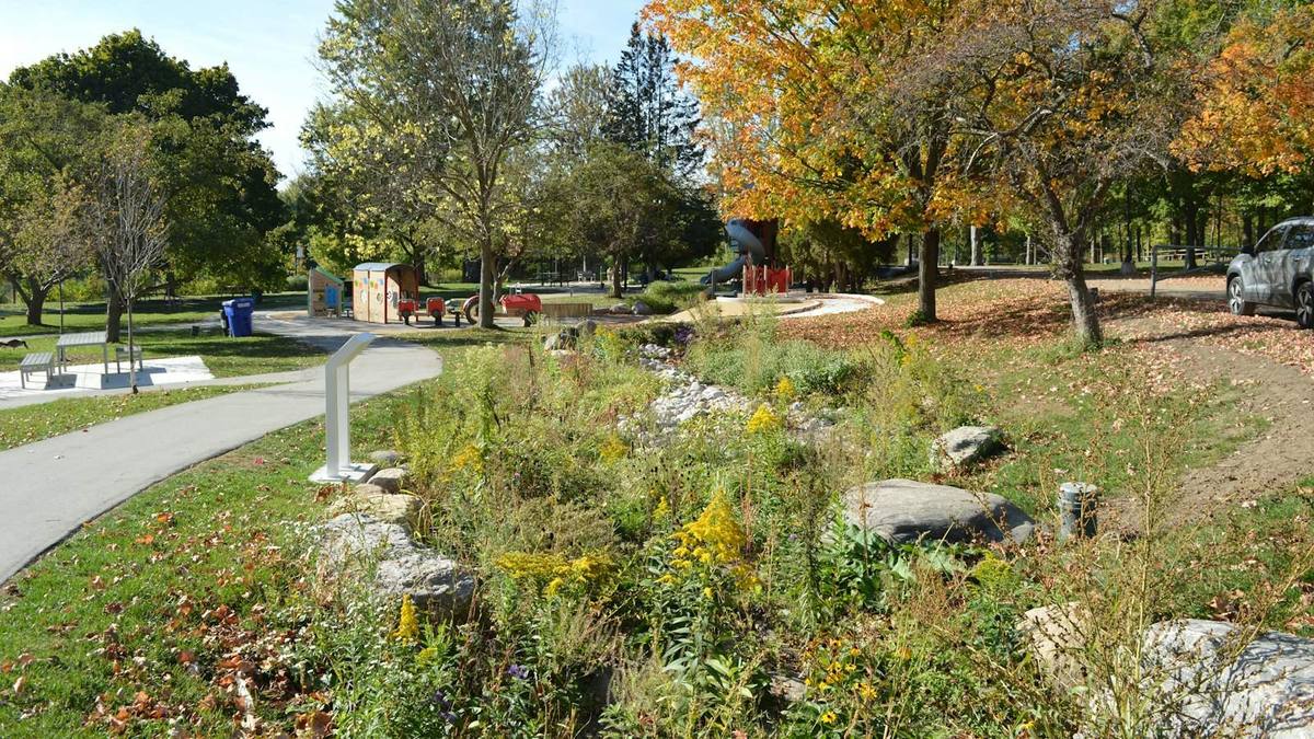 A sunny autumn park with a children's playground among the trees