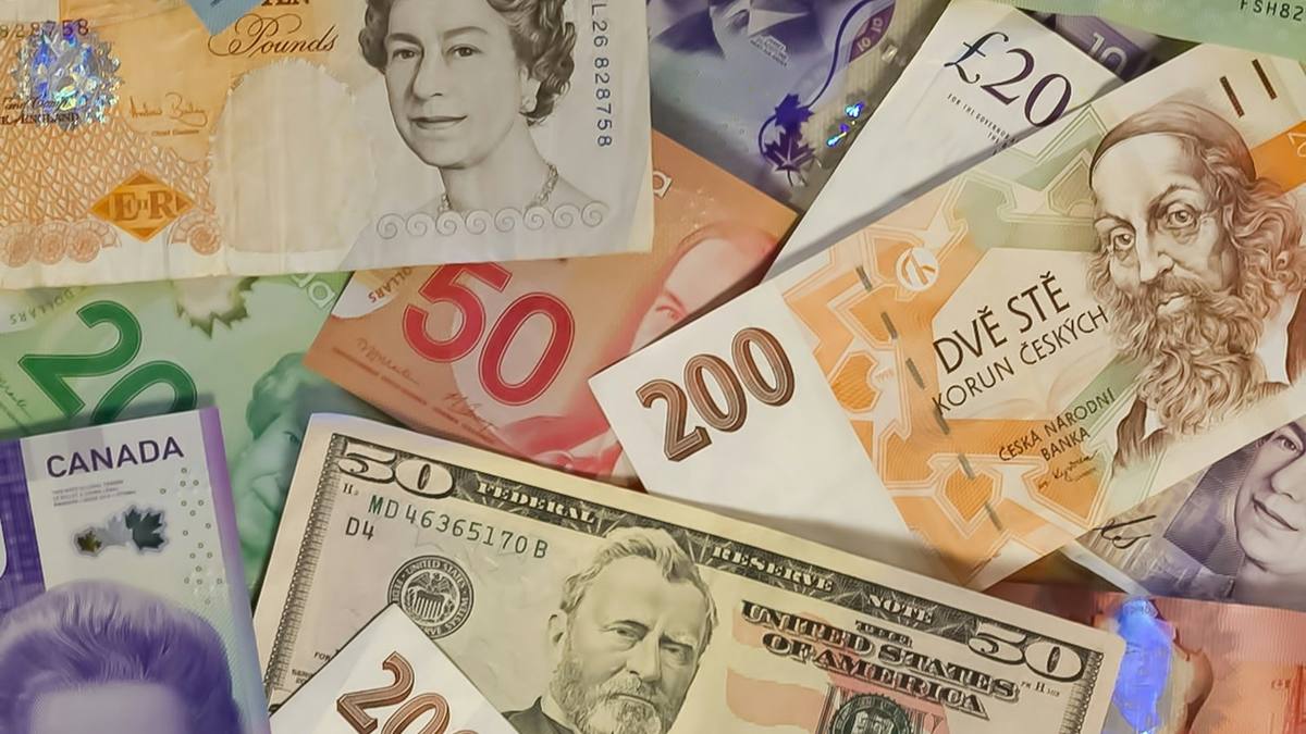 Banknotes from several countries, including British pounds and US dollars, spread out together