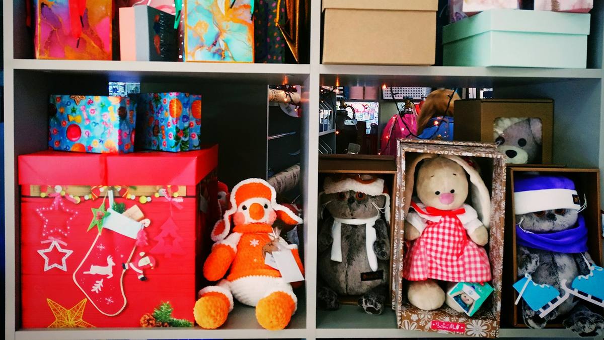 Shelves stacked with wrapped gift boxes and soft toys