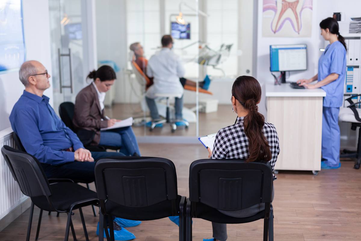 Image of patients waiting in a dentist waiting room.