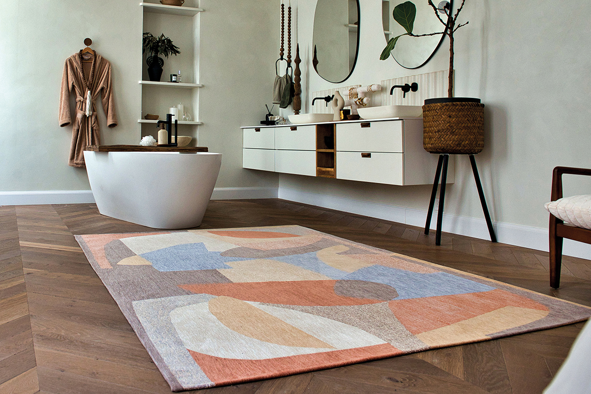A contemporary bathroom featuring a eye-catching rug from Louis De Poortere.
