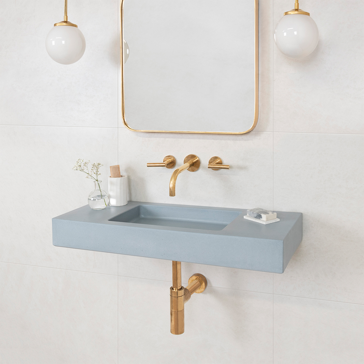 A retro-inspired bathroom sink featuring art Nouveau curves and orb lights from Spark & Bell.